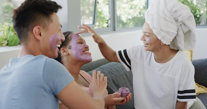 Young Asian man and biracial women enjoy a spa day at home