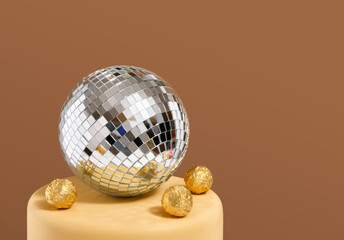 Mirrored glittering disco ball and gold foil candy. Copy space for text.