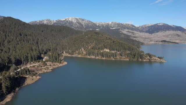 Ascending Drone view of Aoos spring lake flying high altitude Greece