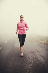 Nature, fitness and young woman running on mountain road for race, marathon or competition training. Sports, exercise and female athlete with cardio workout in misty outdoor woods or forest. - obrazy, fototapety, plakaty