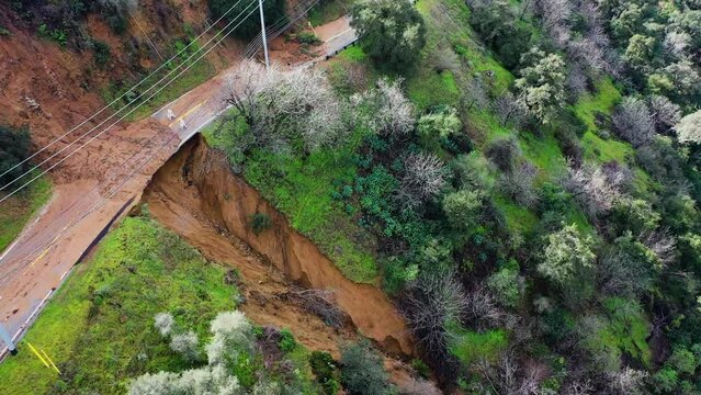 Aerial view of a landslide at a road in the mountains of rainy California, USA