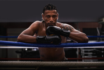 Portrait, exercise and black man boxer in ring at gym for combat sports training or competition....