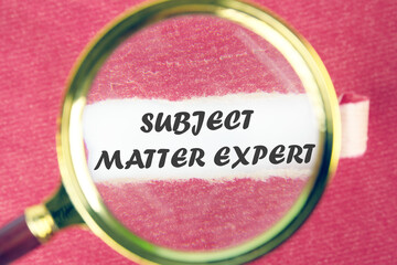 Text Subject Matter Expert through a magnifying glass under a torn piece of red paper