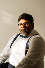 Confident body positivity man looking at camera in studio portrait