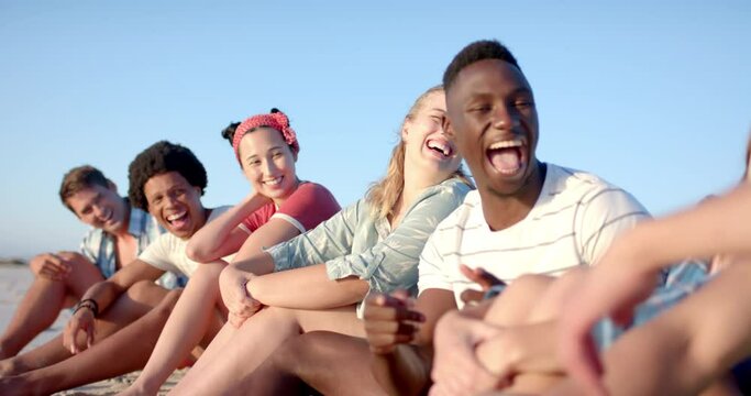 Diverse group of friends enjoy a beach day together