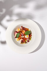 Elevated View of Zucchini Seafood Sauté with Shrimp on a Shadowed White Background