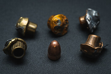 Crumpled spent bullets from a 9mm pistol.
