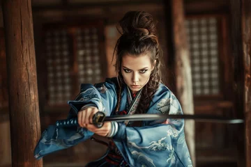 Zelfklevend Fotobehang woman with a samurai katana practicing martial arts © Jorge Ferreiro