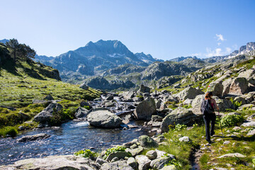 Young hiker girl summit to Ratera Peak in Aiguestortes and Sant Maurici National Park, Spain