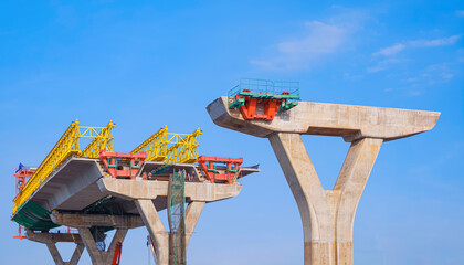Metal launching gantry on foundation of elevated expressway structure with engineers group is...