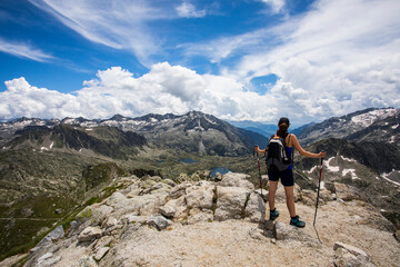 Young hiker girl summit to Montardo Peak in AIguestortes and Sant Maurici National Park, Spain
