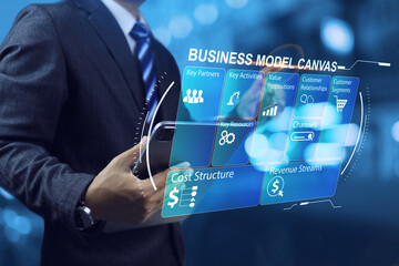 Business model canvas or BMC with businessman using tablet to planning and study of starting a business, market research and customer segment, sales channels income and expenses - obrazy, fototapety, plakaty
