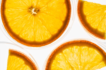 Slices of orange on white backlit background. Close up. Top view. High resolution product