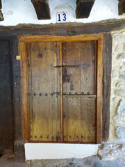 
vertical photo of old wooden door of a home