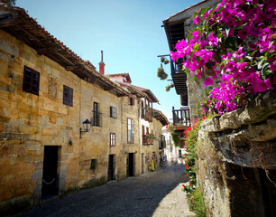 Perspective view of houses lined up in narrow streets of the old town Santillana del Mar.