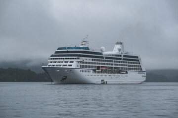 Luxury cruiseship cruise ship liner Regatta anchored in Sitka Bay, Alaska on foggy low hanging...