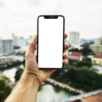 hand holding smartphone blank screen taking photo