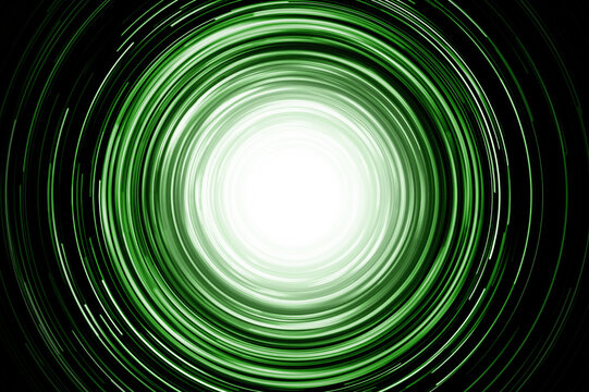 Neon circle lines with empty copy space isolated on black background. Colorful led lights long exposure rotation photo. Eco shiny light glow. Cosmos space planet abstraction. Green vortex spiral.