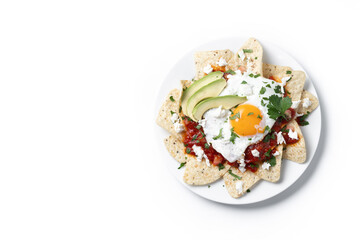 Traditional Mexican breakfast red chilaquiles with egg isolated on white background. Top view. Copy space