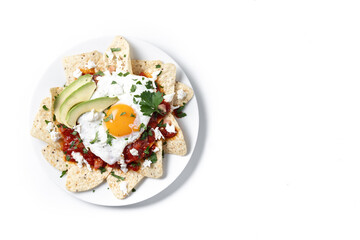 Traditional Mexican breakfast red chilaquiles with egg isolated on white background. Top view. Copy...