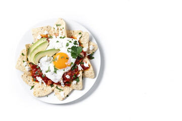 Traditional Mexican breakfast red chilaquiles with egg isolated on white background. Top view. Copy space
