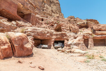 Wadi Musa, Jordan - A couple of 4 wheel drive pick ups parked in some caves in Petra, Jordan