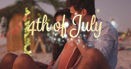 Independence day text and spots of light against caucasian couple embracing each other at the beach