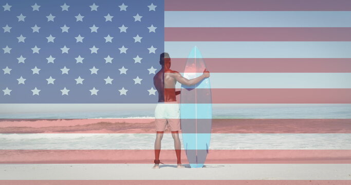 Image of american flag jigsaw puzzles revealing confetti and man with surfboard on beach - Powered by Adobe