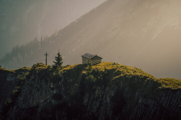 small cabin on a misty morning in the mountains