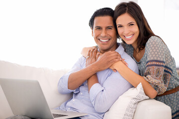 Portrait, hug and couple on sofa with laptop for internet, browse and search for movie...