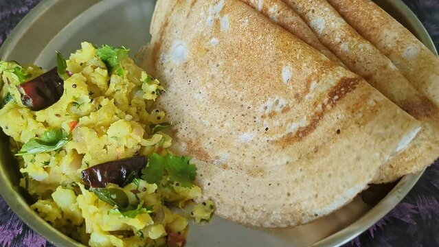 Panoramic shot of homemade masala dosa with mashed potatoes served on a plate on the table