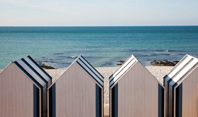 white beach huts on the coast in France