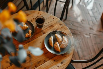 steaming traditional pierogi dumplings rest on a wooden table in a modern cafe, viewed from above