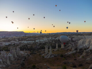 Colorful balloons fly over the valley of fabulous chimneys in Nevsehir, Goreme, Cappadocia, Turkey....