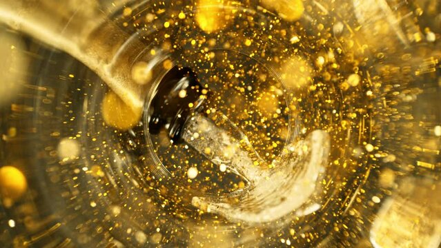 Super Slow Motion of Pouring Champagne Wine into Glass with Glittering Particles. Unique Perspective of View from Glass Bottom. Filmed on High Speed Cinema Camera, 1000 fps.