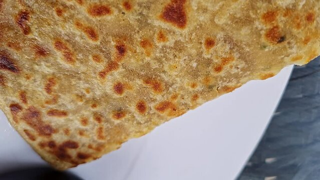 Pan shot of Indian famous food aloo paratha or flatbread served with yogurt and chutney