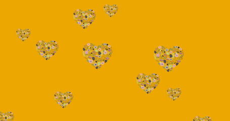 Image of flower hearts moving in hypnotic motion with copy space on orange background