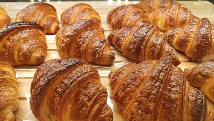Fresh croissants on display in the bakery window