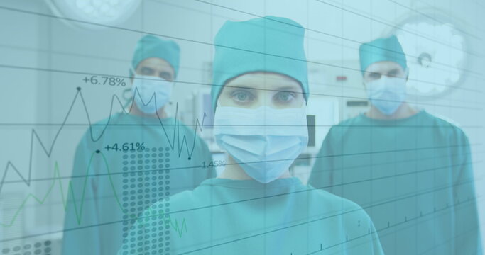 Financial data processing against portrait of team of surgeons wearing face masks