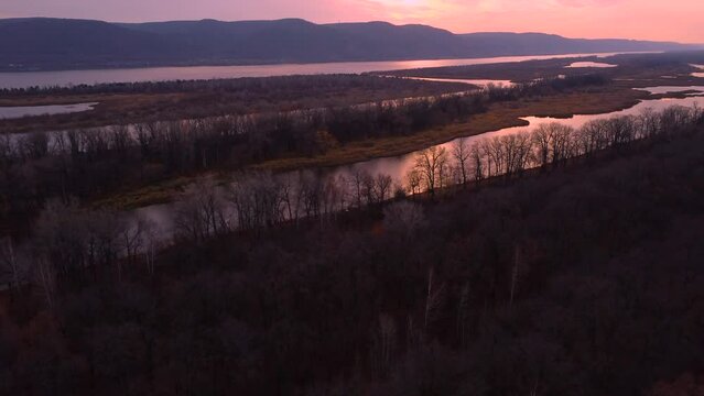 Autumn Overlook Aerial Views of Volga River, Forest, and the Grushinsky Festival Meadow in Warm Glow. Nature of Russia view from a drone in autumn