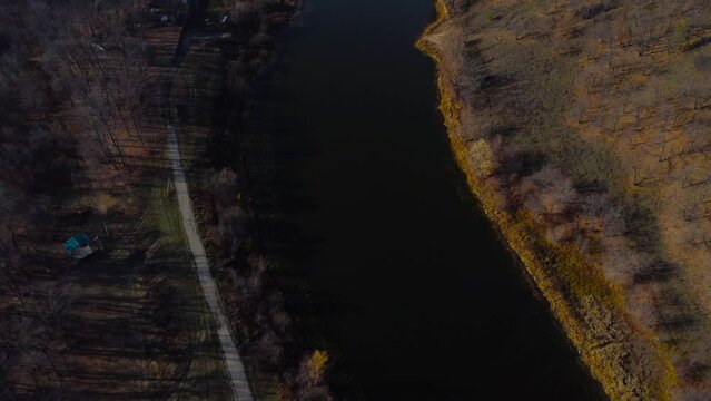 Autumn Overlook Aerial Views of Volga River, Forest, and the Grushinsky Festival Meadow in Warm Glow. Nature of Russia view from a drone in autumn