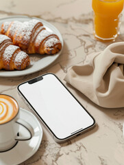 Mockup Smartphone with White Screen on Marble Table: Top View of Mobile Phone Mockup with Blank Screen next to Breakfast with Coffee, Croissants and Orange Juice
