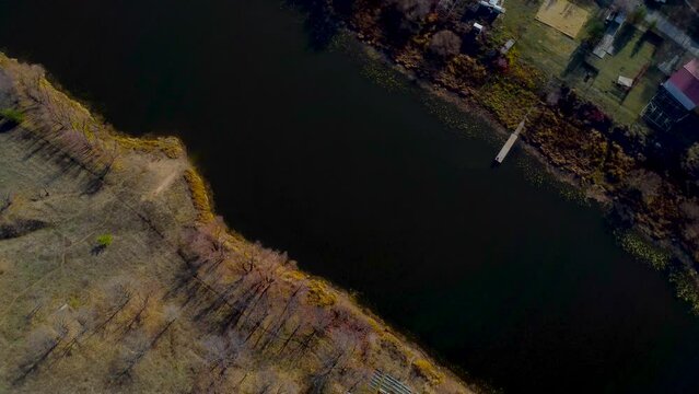 Autumn Overlook Aerial Views of Volga River, Forest, and the Grushinsky Festival Meadow in Warm Glow. Nature of Russia view from a drone in autumn
