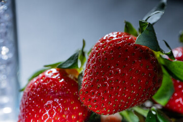 Fresh nice red strawberries close up on a light background