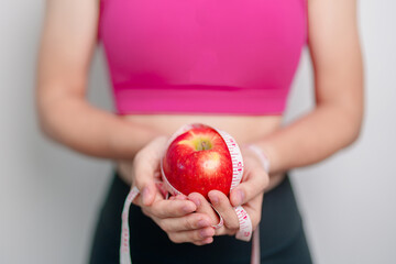 woman hand hold red Apple, happy female fitness choose fruit is Healthy food. Dieting control,...