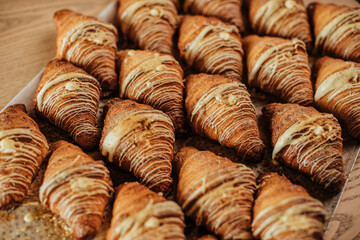 Freshly baked croissants aligned on plate