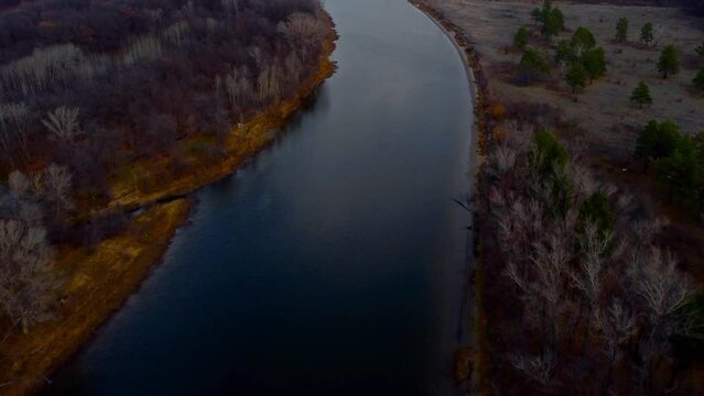Autumn Overlook Aerial Views of Volga River, Forest, and the Grushinsky Festival Meadow in Warm Glow. Nature of Russia view from a drone in autumn