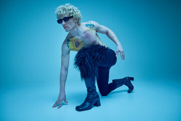 Portrait of male model in striking fashion-forward dance pose, mixing allure and alternative style...