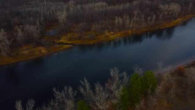 Autumn Overlook Aerial Views of Volga River, Forest, and the Grushinsky Festival Meadow in Warm Glow. Nature of Russia view from a drone in autumn
