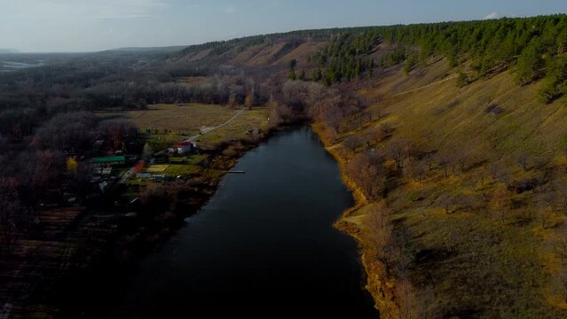 Autumn Overlook Aerial Views of Volga River, Forest, and the Grushinsky Festival Meadow in Warm Glow. Nature of Russia view from a drone in autumn